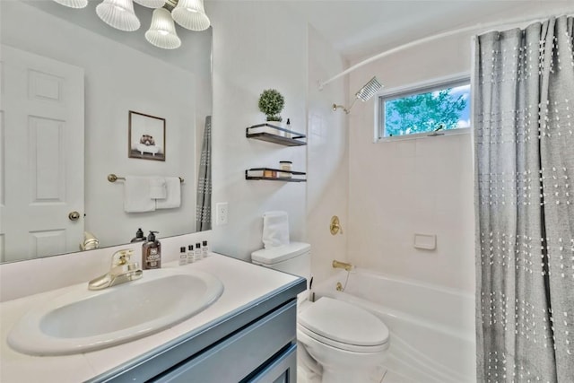 bathroom with vanity, shower / tub combo with curtain, and toilet