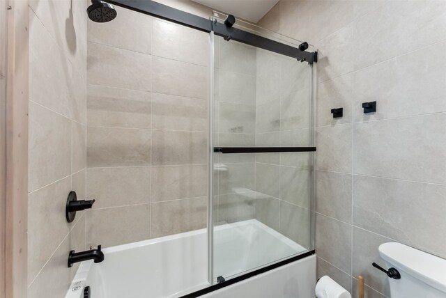 96 River Run Rd Unit A, Keystone, CO 80435 - full bath featuring toilet, bath / shower combo with glass door, and tile walls