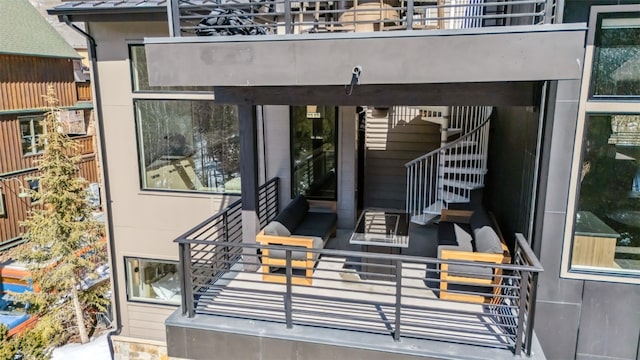 doorway to property featuring an outdoor living space and a balcony