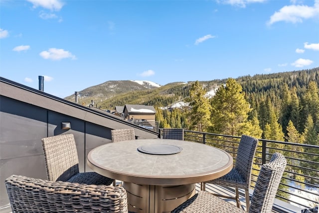 deck with a mountain view and a view of trees