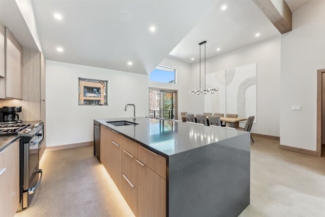 96 River Run Rd Unit A, Keystone, CO 80435 - kitchen featuring modern cabinets, appliances with stainless steel finishes, a sink, and a center island with sink