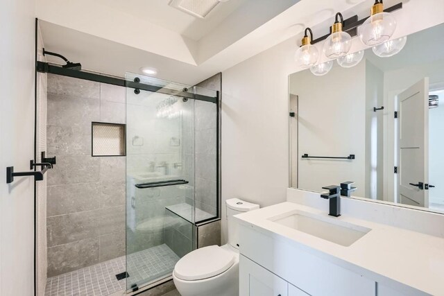 234 Frisco Aly Unit D, Frisco, CO 80443 - bathroom with toilet, a stall shower, visible vents, and vanity