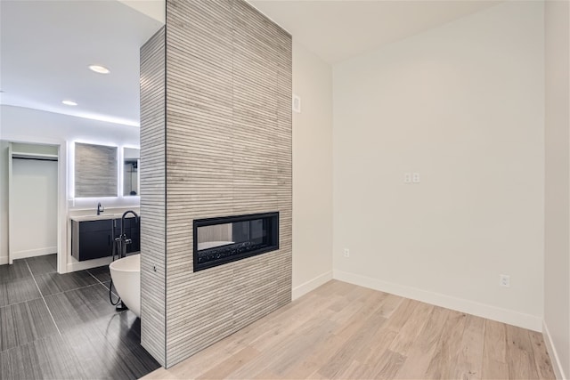 234 Frisco Aly Unit D, Frisco, CO 80443 - interior space featuring light wood-type flooring, a tile fireplace, baseboards, and recessed lighting