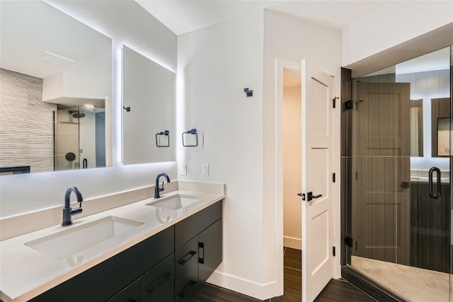 234 Frisco Aly Unit D, Frisco, CO 80443 - bathroom featuring a shower stall, wood finished floors, a sink, and double vanity
