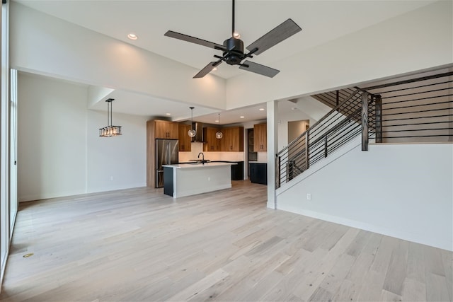 234 Frisco Aly Unit D, Frisco, CO 80443 - unfurnished living room featuring light wood finished floors, a sink, baseboards, recessed lighting, and ceiling fan