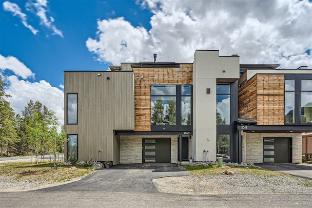 234 Frisco Aly Unit D, Frisco, CO 80443 - contemporary home featuring a garage, aphalt driveway, and stone siding
