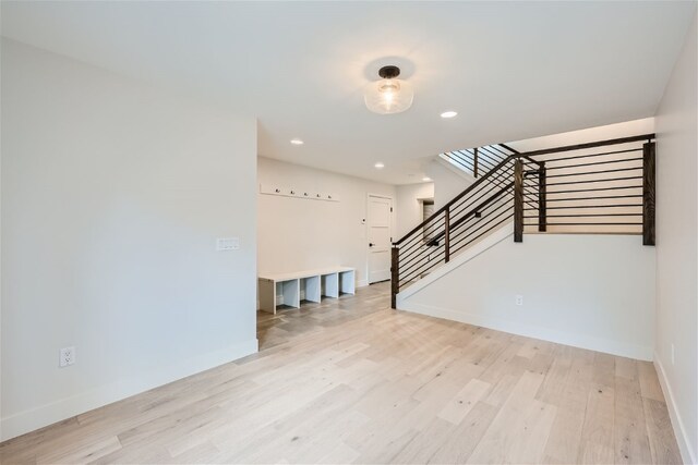 234 Frisco Aly Unit D, Frisco, CO 80443 - unfurnished living room featuring recessed lighting, stairway, light wood finished floors, and baseboards