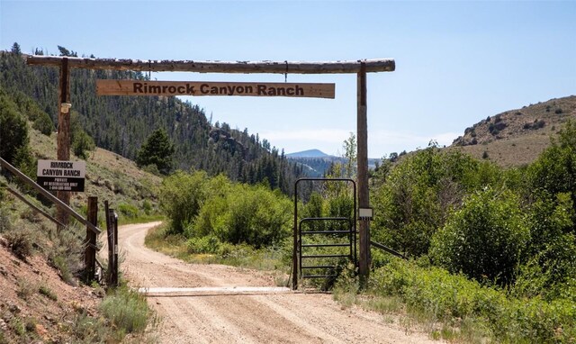 1211 County Road 213, Parshall, CO 80468 - view of road featuring a forest view, a gate, and a mountain view
