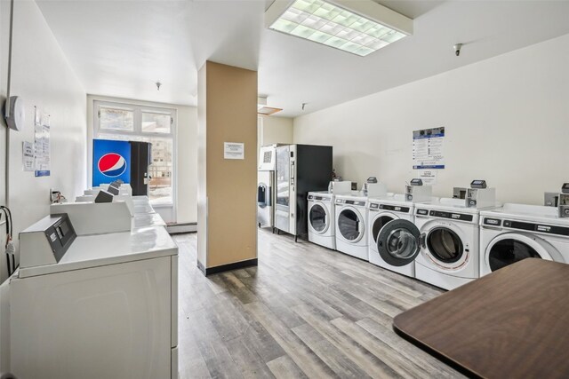 189 Ten Mile Cir Unit 362, Copper Mountain, CO 80443 - shared laundry area featuring baseboard heating, washer and clothes dryer, and wood finished floors