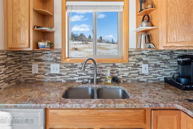 kitchen with tasteful backsplash, white dishwasher, open shelves, a sink, and light brown cabinetry