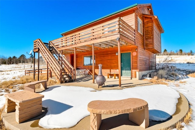 exterior space with a wooden deck, a patio, and stairway
