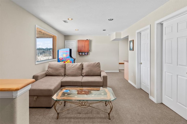 carpeted living room with recessed lighting, visible vents, and baseboards