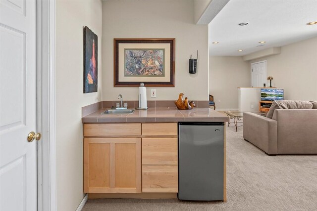 bar featuring recessed lighting, wet bar, a sink, freestanding refrigerator, and light colored carpet
