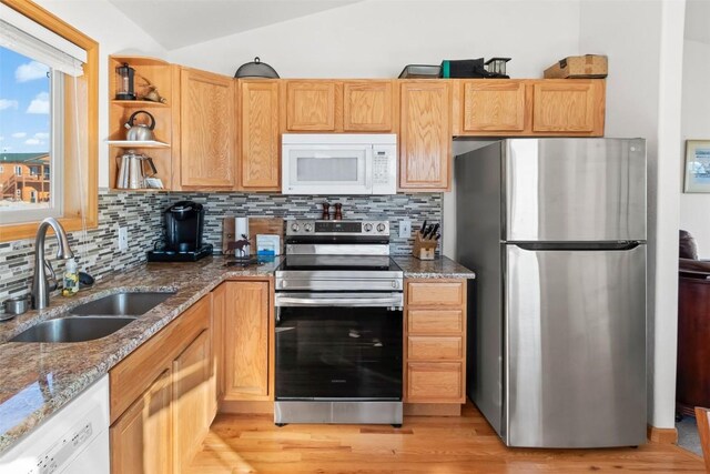 kitchen with open shelves, tasteful backsplash, stainless steel appliances, and a sink