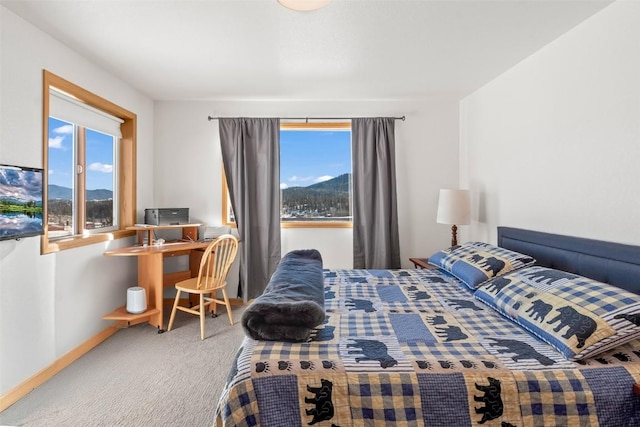 bedroom featuring carpet floors, multiple windows, and baseboards