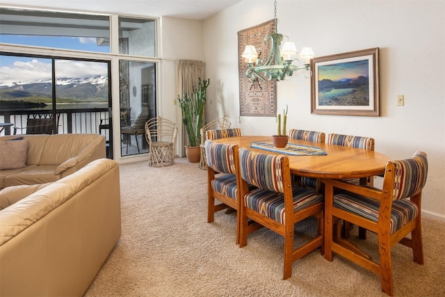 576 Tenderfoot St Unit 163, Dillon, CO 80435 - dining space featuring light colored carpet, a chandelier, and a water view