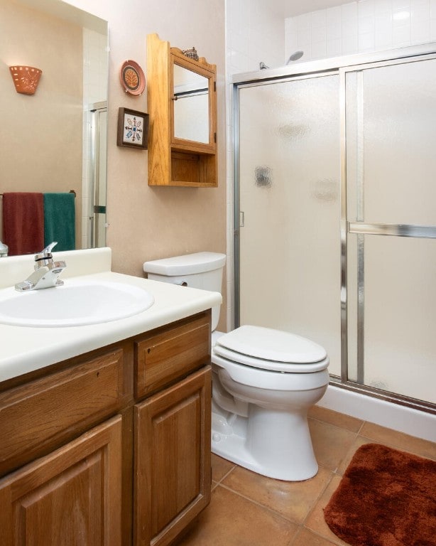 576 Tenderfoot St Unit 163, Dillon, CO 80435 - bathroom with tile patterned floors, toilet, a stall shower, and vanity