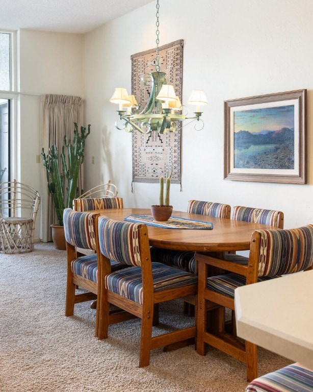 576 Tenderfoot St Unit 163, Dillon, CO 80435 - dining room featuring light carpet and a chandelier
