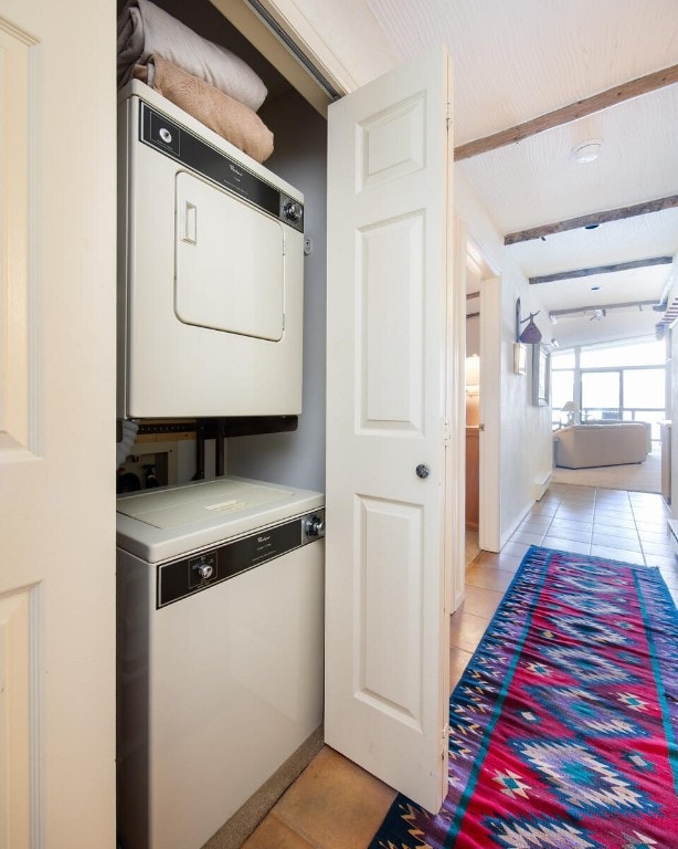 576 Tenderfoot St Unit 163, Dillon, CO 80435 - laundry area with stacked washer / dryer, light tile patterned floors, and baseboards
