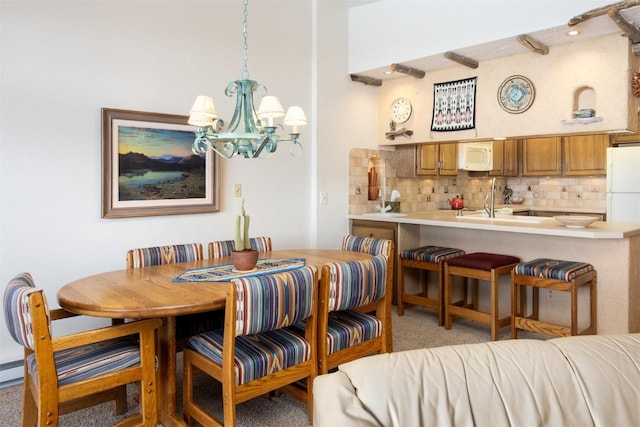 576 Tenderfoot St Unit 163, Dillon, CO 80435 - dining area featuring a chandelier and light carpet