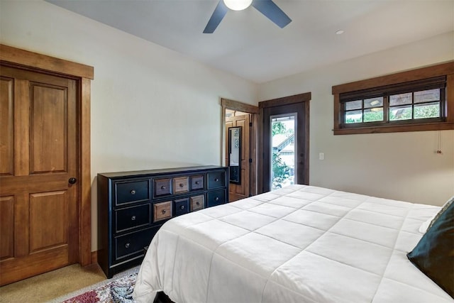 bedroom featuring access to outside, a ceiling fan, and light carpet