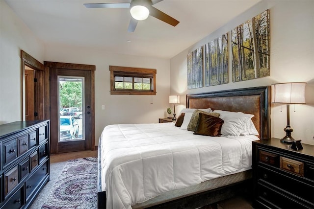 carpeted bedroom featuring a ceiling fan and access to outside