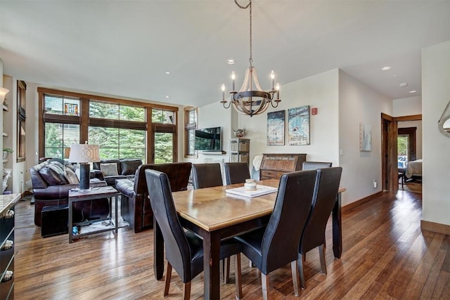 dining room with baseboards, recessed lighting, a chandelier, and wood-type flooring