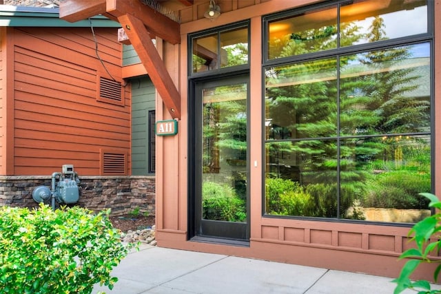 entrance to property with stone siding