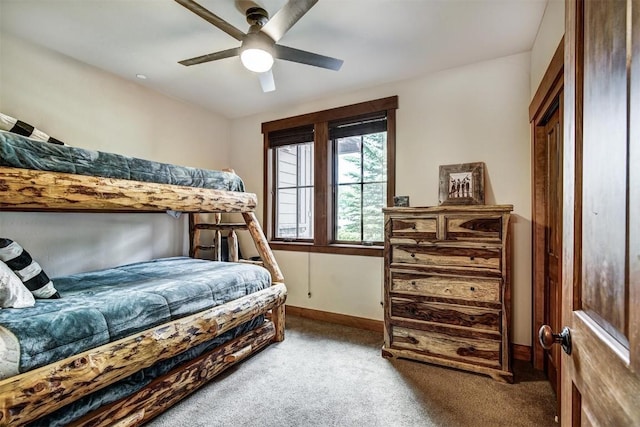 carpeted bedroom with a ceiling fan and baseboards