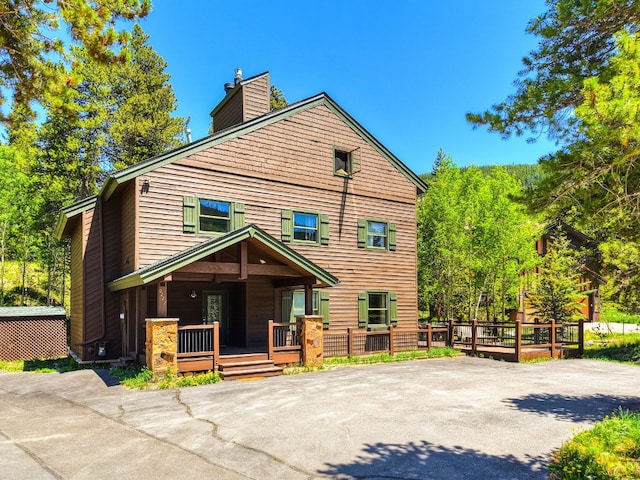227 Mountain View Dr, Breckenridge, CO 80424 - view of front of house featuring a chimney and a porch