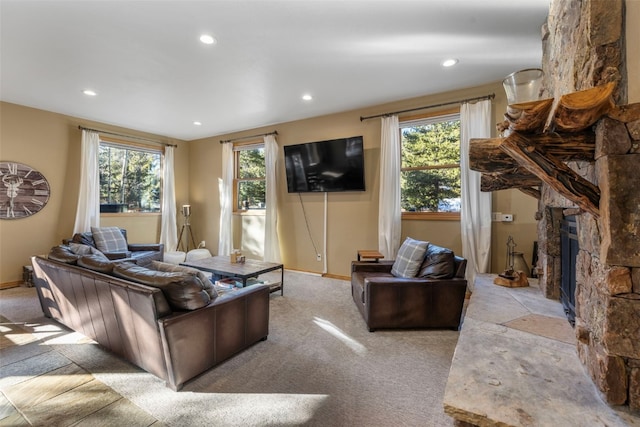 carpeted living area featuring plenty of natural light, a fireplace, and recessed lighting