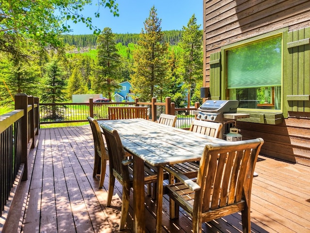 227 Mountain View Dr, Breckenridge, CO 80424 - deck with outdoor dining area, a view of trees, and grilling area