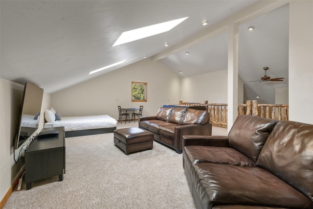 living room with baseboards, light colored carpet, and vaulted ceiling with skylight