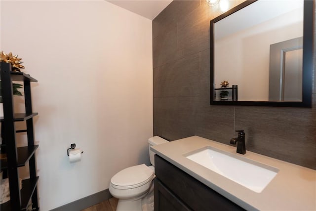 260 N Fuller Placer Rd, Breckenridge, CO 80424 - half bathroom featuring vanity, tasteful backsplash, and tile walls
