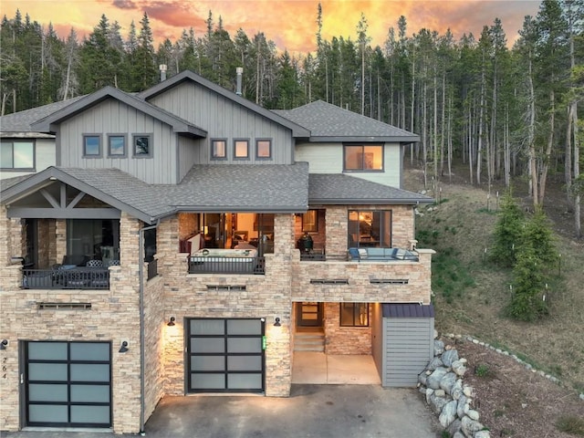 260 N Fuller Placer Rd, Breckenridge, CO 80424 - view of front of house featuring an attached garage, a shingled roof, and stone siding