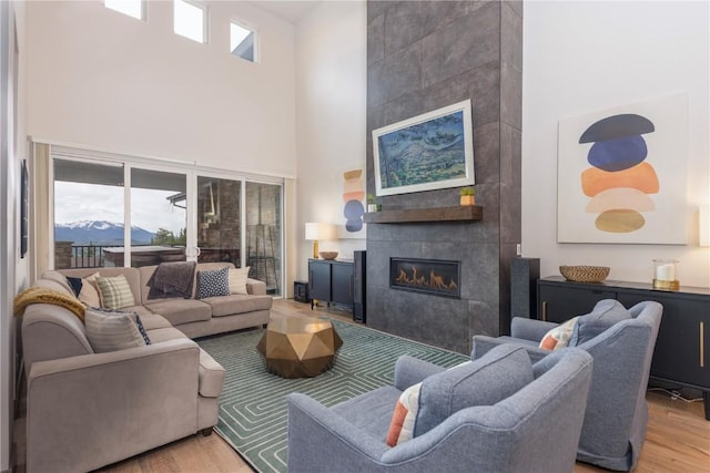 260 N Fuller Placer Rd, Breckenridge, CO 80424 - living room with a towering ceiling, wood finished floors, and a tile fireplace