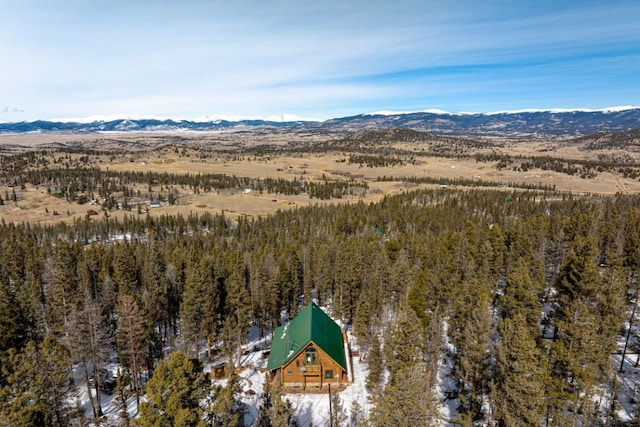 aerial view featuring a forest view and a mountain view