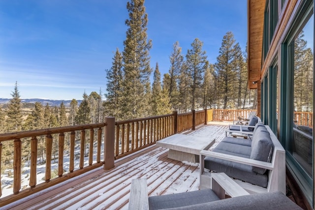 snow covered deck featuring a mountain view