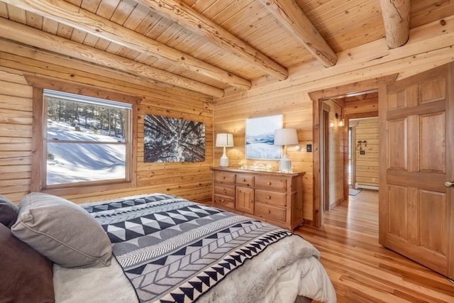bedroom with light wood finished floors, a baseboard heating unit, wooden walls, beamed ceiling, and wooden ceiling