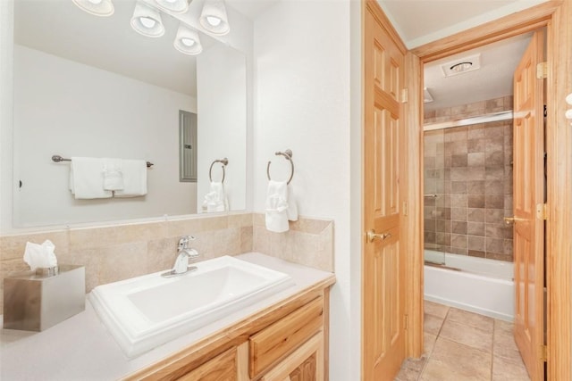 bathroom featuring visible vents, tile patterned floors, vanity, and enclosed tub / shower combo