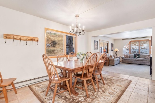 dining area with baseboard heating, a chandelier, light tile patterned floors, and a healthy amount of sunlight