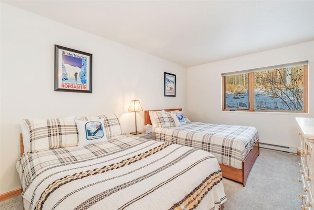 bedroom featuring a baseboard heating unit and light colored carpet