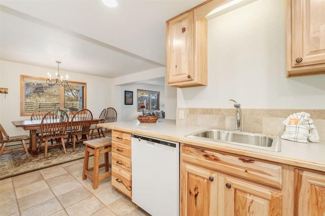 kitchen with light brown cabinetry, white dishwasher, a sink, and light countertops