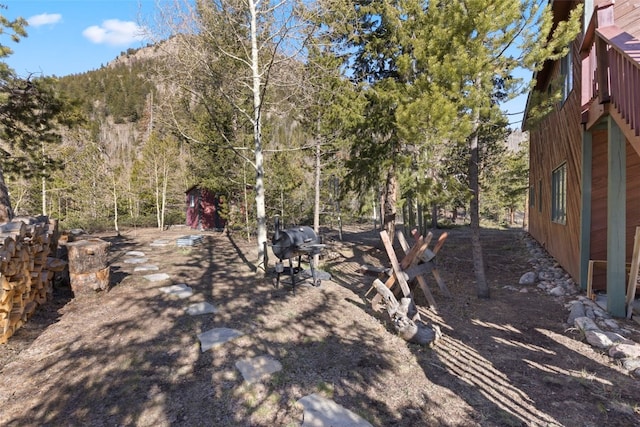 view of yard with a forest view