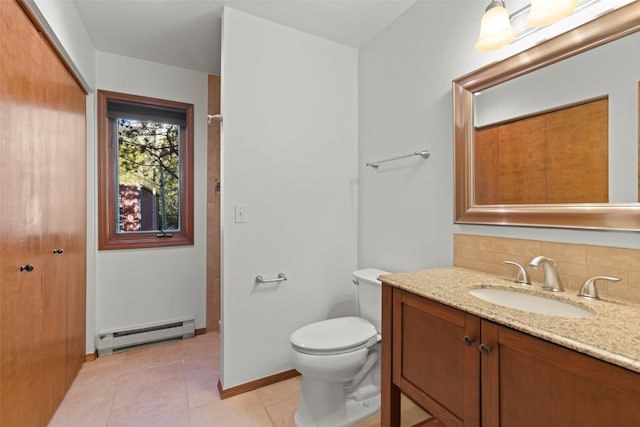 bathroom with baseboard heating, tile patterned flooring, toilet, vanity, and baseboards