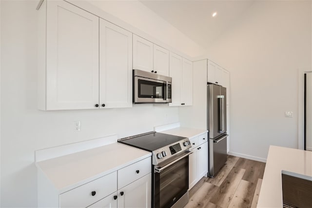 350 Stan Miller Unit 100, Breckenridge, CO 80424 - kitchen featuring stainless steel appliances, white cabinetry, light wood finished floors, light countertops, and recessed lighting