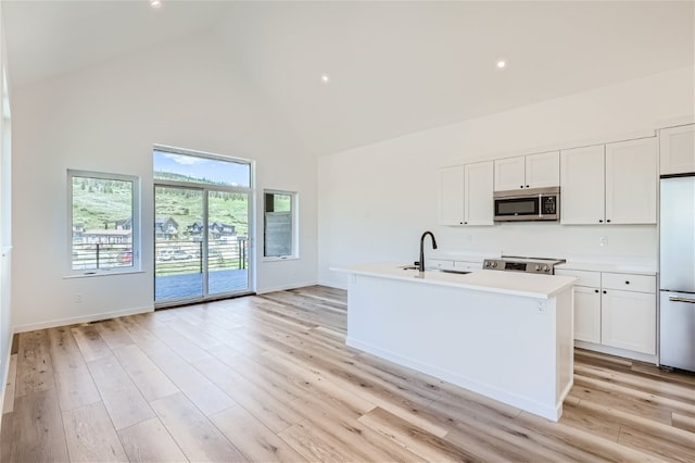 350 Stan Miller Unit 100, Breckenridge, CO 80424 - kitchen featuring stainless steel microwave, high vaulted ceiling, built in refrigerator, a sink, and electric stove