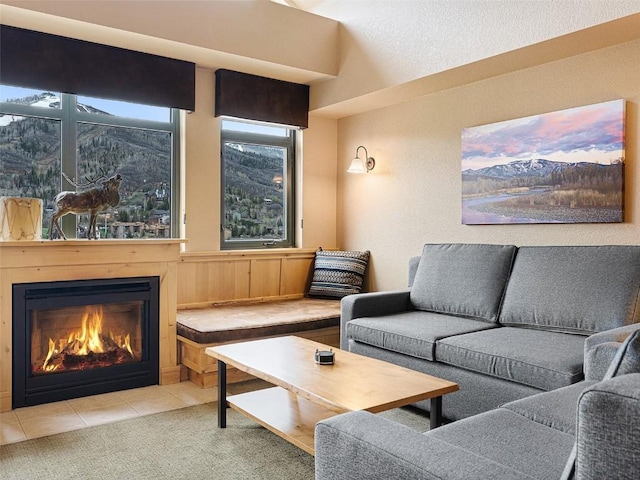 tiled living room with a glass covered fireplace