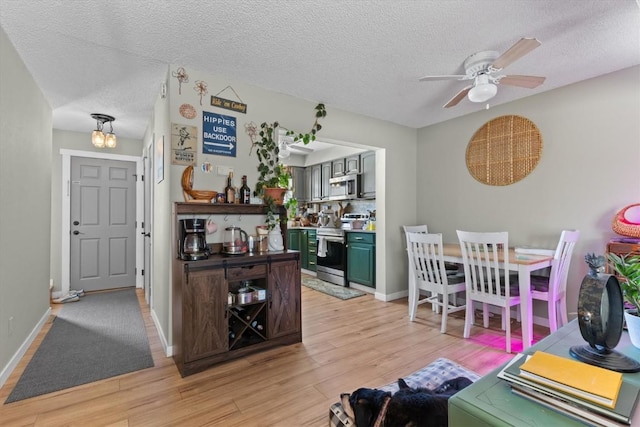 interior space with ceiling fan, light hardwood / wood-style floors, and a textured ceiling