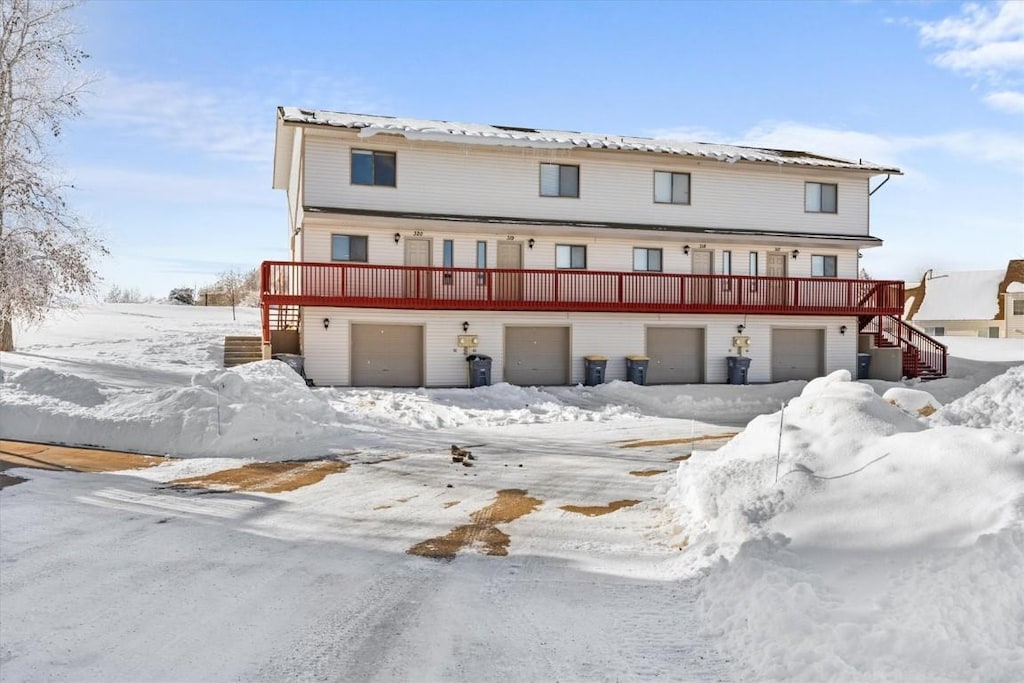 view of front of property featuring a garage and a deck